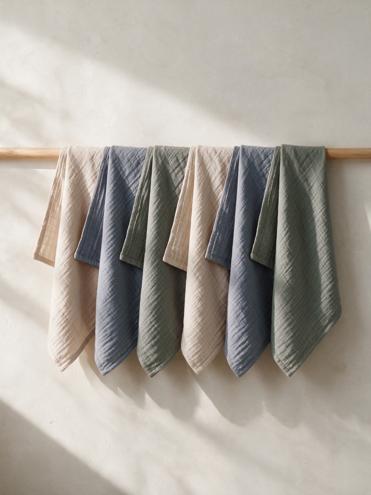 Morning Mist muslin squares hanging on a wooden rail