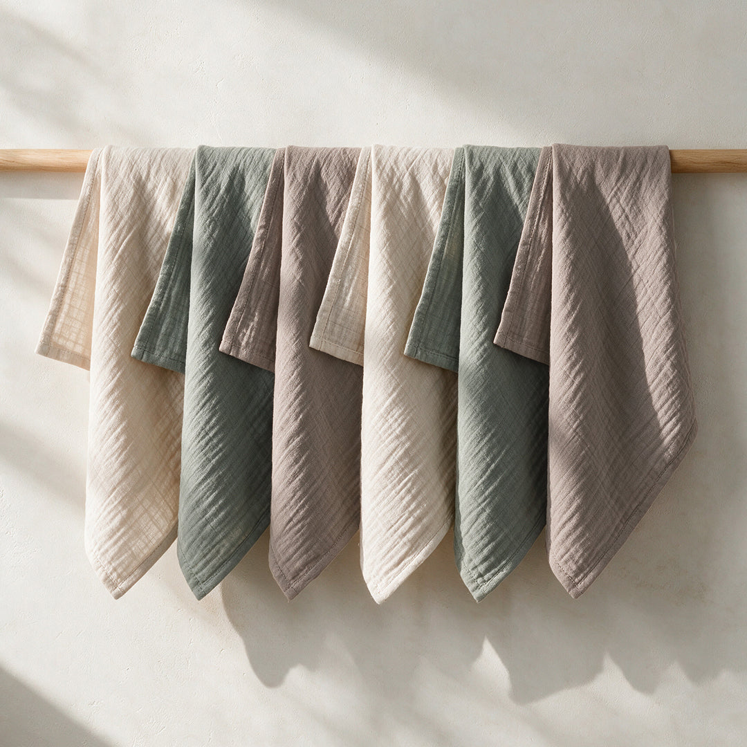Wild Sage organic cotton muslin squares drying on a wooden rail